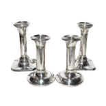 Two pairs of silver candlesticks, filled (4)