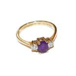 An 18 carat gold amethyst and diamond three stone ring, finger size O. The amethyst is chipped.