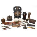 A tray of tribal carved souvenir items including a mask and various figures, together with treen and