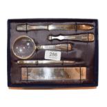 An Elizabeth II Royal Mail Silver-Mounted Desk-Set, in fitted case, including: a ruler; a paper-