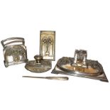 An Art Nouveau silver plated desk set (plating badly worn), including a desk standish, blotter,