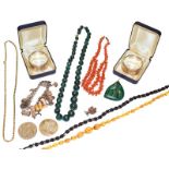 A quantity of jewellery including a malachite necklace and pendant, a coral necklace, a silver charm