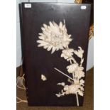 A Japanese Meiji period panel applied with carved ivory sections in the form of blossom and a