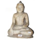 A South East Asian carved alabaster statue of a seated Buddha, 35cm (a.f)Naturalistically carved and