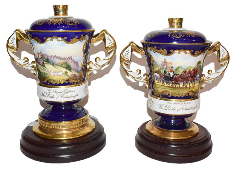 Two Aynsley twin handled cups and covers, one for Prince Philip's 70th birthday, the other for his