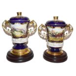 Two Aynsley twin handled cups and covers, one for Prince Philip's 70th birthday, the other for his