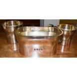 A Large Krug pewter Champagne ice bucket, a Krug Magnum pewter Champagne ice bucket and a similar