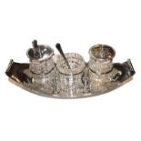 Silver oval condiment stand with cut glass bottles