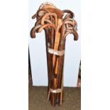 A collection of approximately thirty partridge wood, bamboo, cane and other walking sticks, some