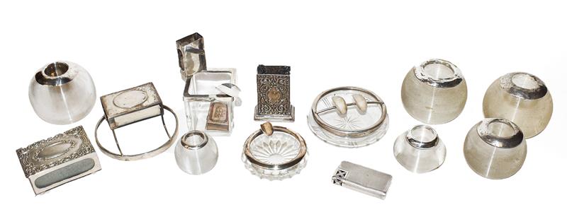 A collection of assorted silver smoking accessories, including: silver-mounted glass match