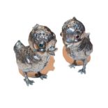 Pair of white metal 'chick' pepperettes, apparently unmarked, 20th century