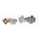 Two 9 carat gold topaz cluster rings, finger sizes O and S; and a gem set ring, stamped '14K',