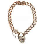 A curb link bracelet, stamped '9' and '.375', with a 9 carat gold padlock clasp, length 18.5cm .