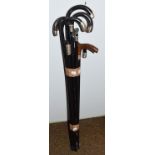 Ten ebonised walking canes, most silver mounted (10)