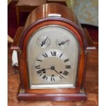 An Edwardian mahogany chiming mantle clock, arched dial with numeral chaptering, two dials for