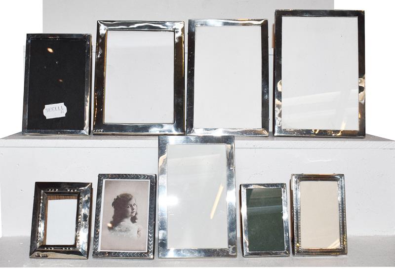 A collection of Nine Various Silver-Mounted Photograph-Frames, each oblong, mostly plain, though two