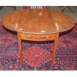 A 19th century mahogany drop leaf occasional table fitted with a drawer opposed by a dummy drawer,