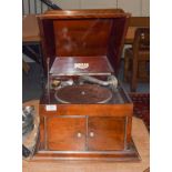 A mahogany cased Regal table top gramophone, together with a small selection of records and spare