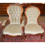 A pair of Victorian ladies and gents button back salon chairs on carved walnut frames (2)