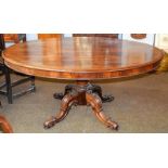 A Victorian rosewood breakfast table, raised on a tapering centre pedestal over four carved scroll