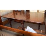 An early Victorian mahogany drop leaf dining table raised on turned supports, 168cm by 114cm open by