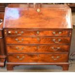 A George III walnut bureau with fitted interior and raised on bracket supports, 103cm by 56cm by