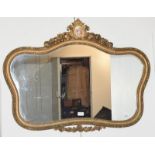A gilt framed mirror surmounted by a painted porcelain roundel, 97cm by 73cm