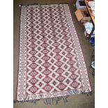 Anatolian design machine made kilim, the aubergine field of stepped guls enclosed by borders of