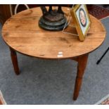 A 19th century pitch pine dining table, diameter 103cm by 74cm