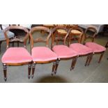 A set of five Victorian carved rosewood balloon back side chairs, together with a further set of