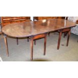 A George III mahogany drop leaf D end dining table, in two sections, 247cm by 108cm by 73cm