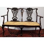 An early 20th century Hepplewhite style carved mahogany two-seater salon sofa, 131cm by 54cm by 92cm