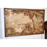 An early 20th century tapestry depicting a woodland scene in an oak frame, 153cm by 98cm