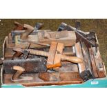 A box of 19th century woodworking planes, including moulding planes, block planes and spoke shave