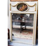 A painted and gilt mirror surmounted with an oval oil painting, 115cm by 175cm