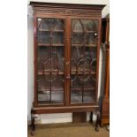 A late 19th century glazed mahogany bookcase, the cornice with blind fret carving above double