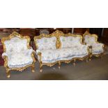 A 20th century Louis XV style giltwood three seater sofa, carved with flowers and foliate scrolls,
