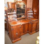 A Victorian mahogany breakfront dressing table with turned column supports and panelled doors,