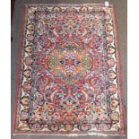 Jozan Rug, the raspberry field with a flowerhead medallion framed by spandrels and ivory borders,