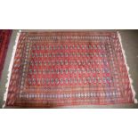 Pakistani Bukhara carpet, the crimson field with columns of quartered guls enclosed by multiple