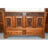 A 20th century carved oak mule chest in the 17th century style, 132cm by 55cm by 85cm