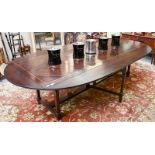 An unusual crossbanded drop-leaf refectory table, bearing label for Royal Antique Collection, with