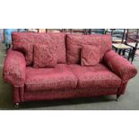 A modern red upholstered two seater sofa