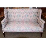 An Edwardian mahogany framed two seater sofa, upholstered in raspberry and teal fabric, 146cm by