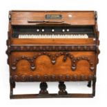 A Victorian Carved Walnut Gothic Revival Pedal Organ, R. F Stevens 107cm by 44cm by 107cm with a