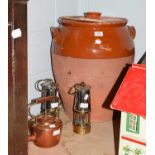 A large glazed terracotta brining jar, two Eccles type-six miners lamps, and a copper kettle