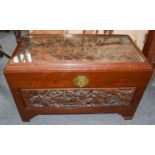 A carved Chinese trunk and a matching nest of four tables