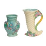 A Clarice Cliff vase with ribbed body and floral decoration and a Clarice Cliff jug of cornucopia