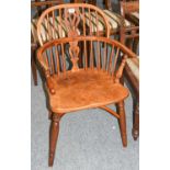 A yew wood Windsor armchair with crinoline stretcher