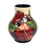 A modern Moorcroft pottery baluster shaped vase, decorated in the Simian design